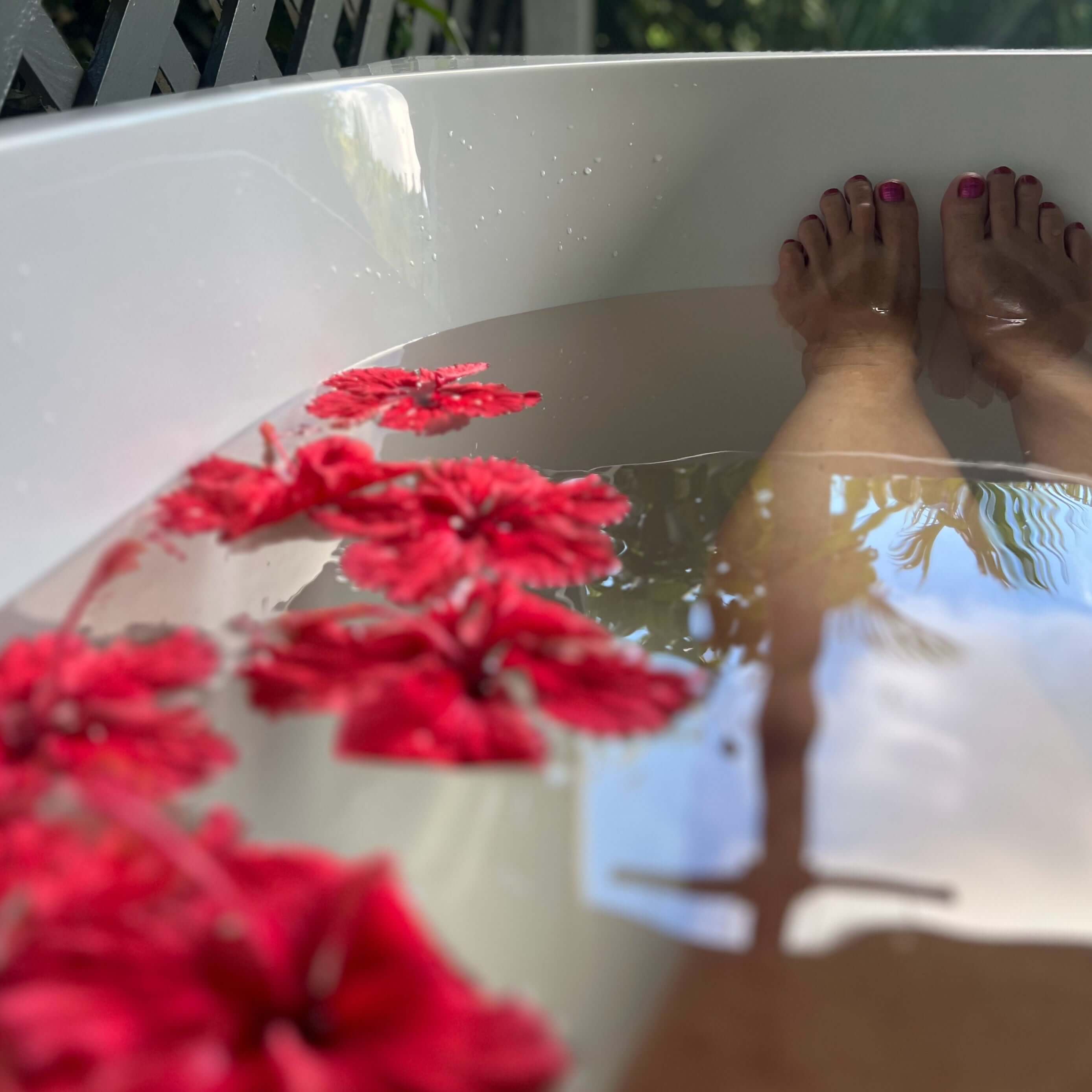 Benefits of Epsom Salts in a relaxing bath with flowers and serene atmosphere.