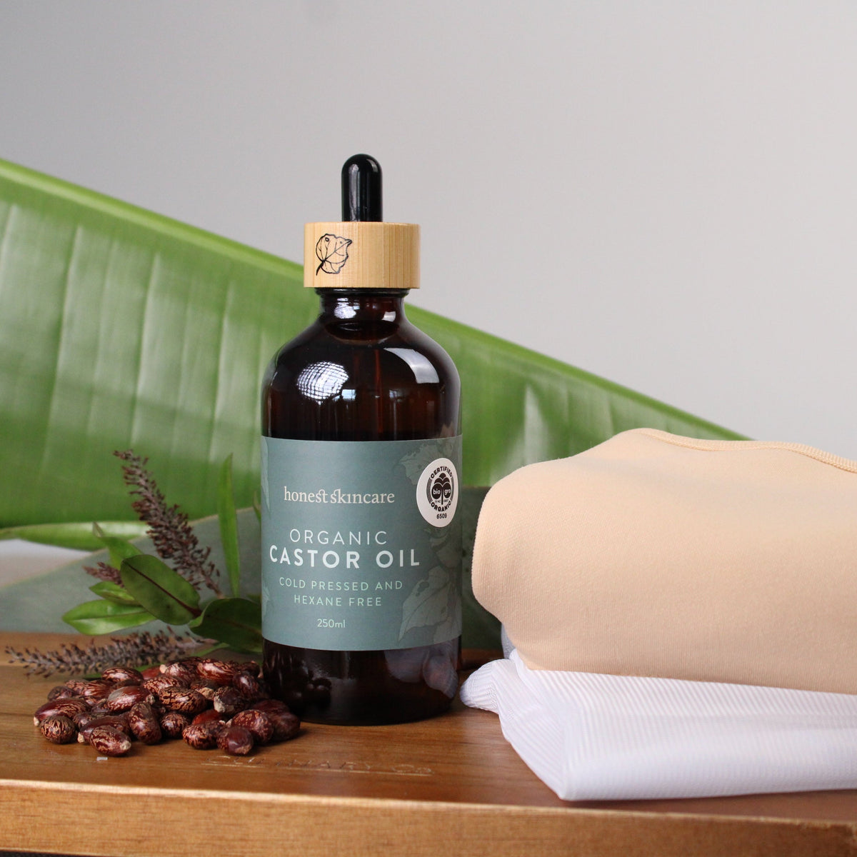 bottle of organic castor oil on a wooden surface, showcasing organic skincare certification benefits for healthy skin
