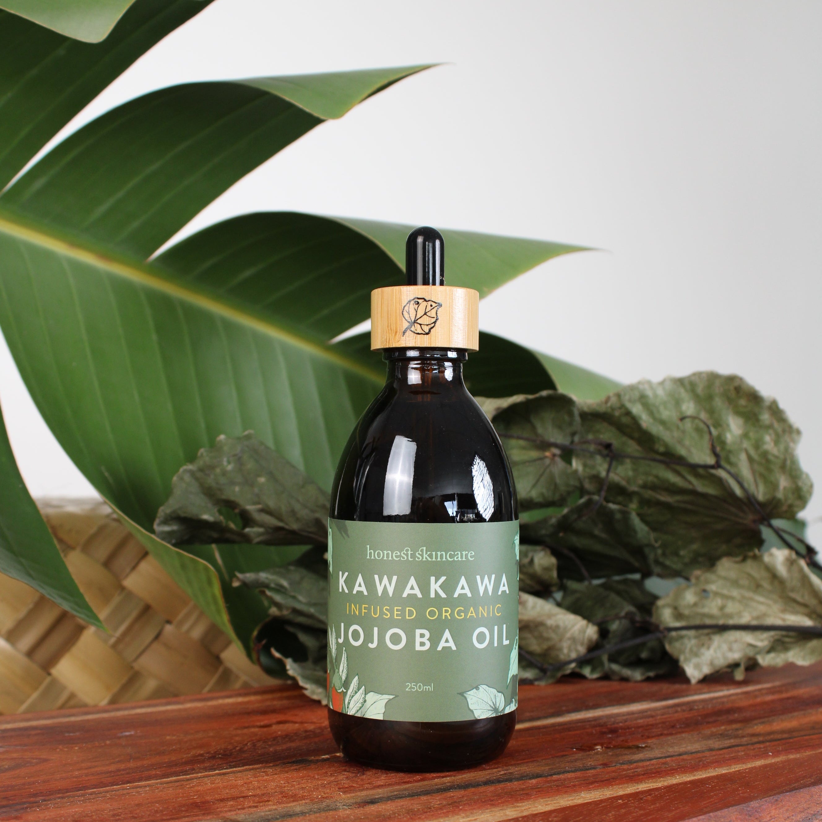 Bottle of Kawakami Jojoba Oil on a leafy background