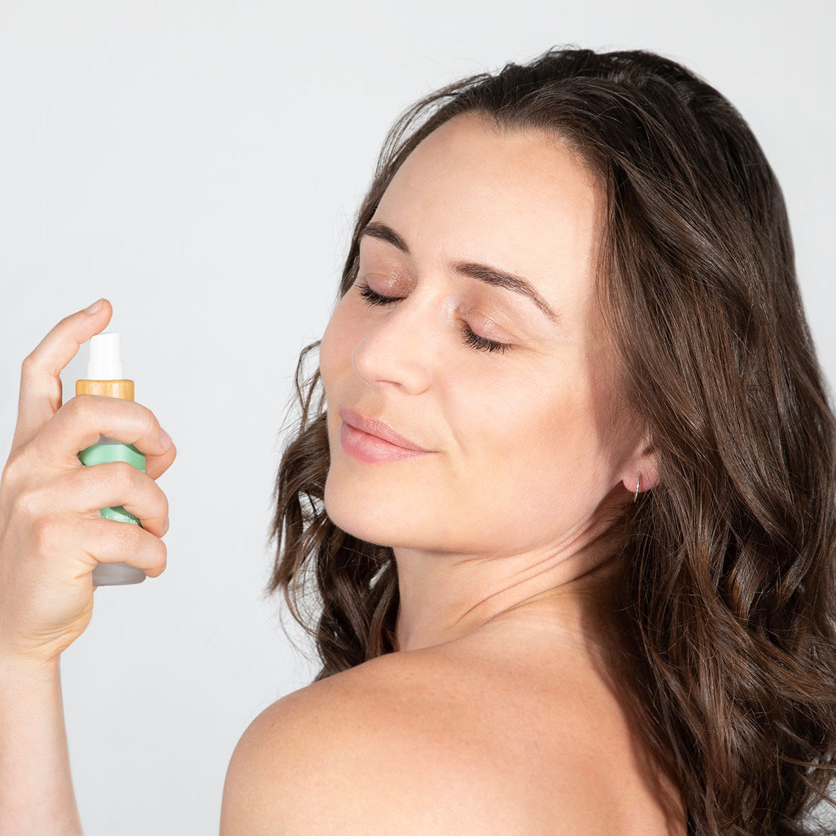 Spraying Kawakawa Face Mist onto Face