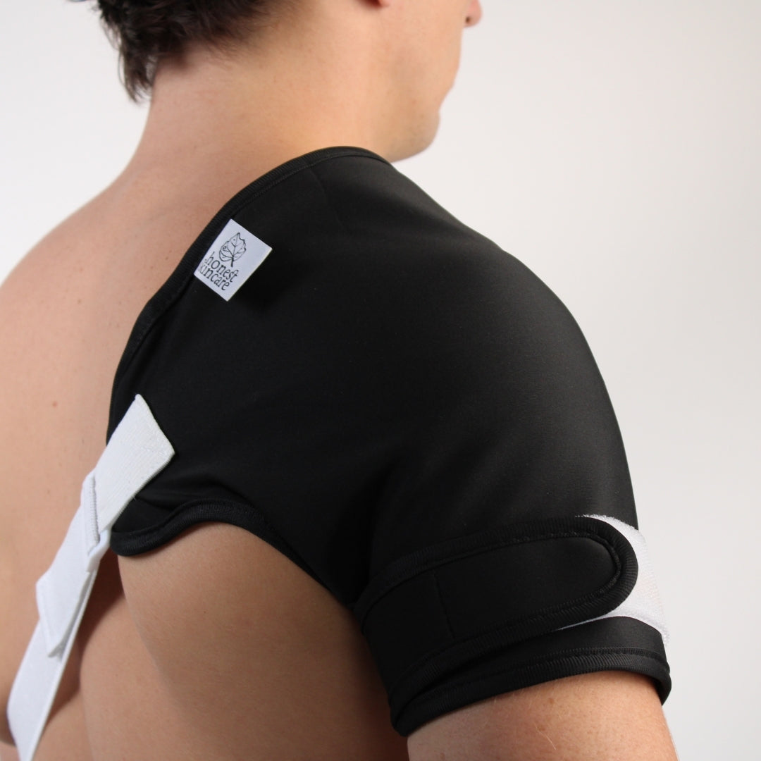 Person wearing castor oil shoulder wrap white accents on a plain background