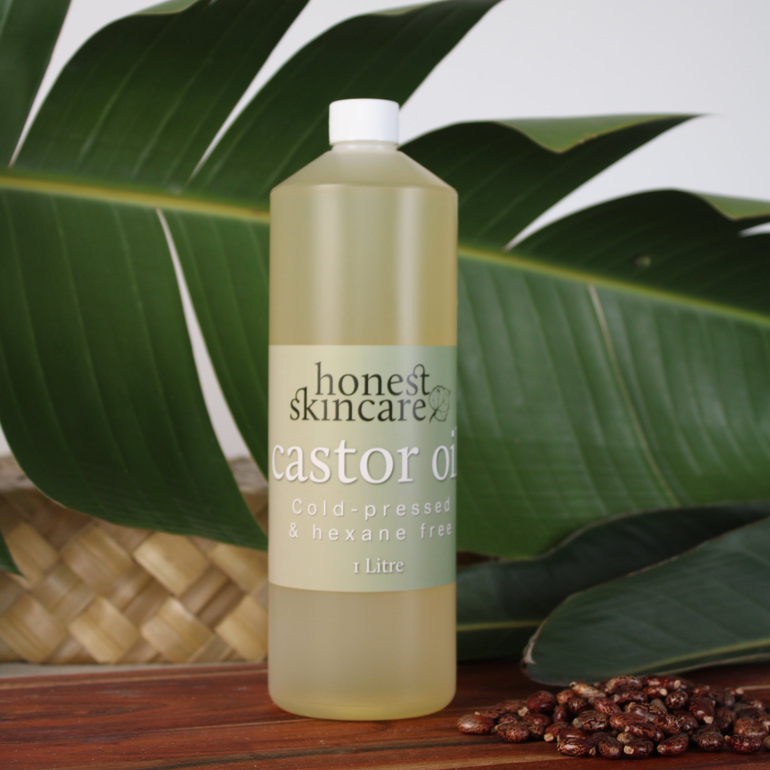 Bottle of Honest Skincare castor oil1 litre on a leafy background