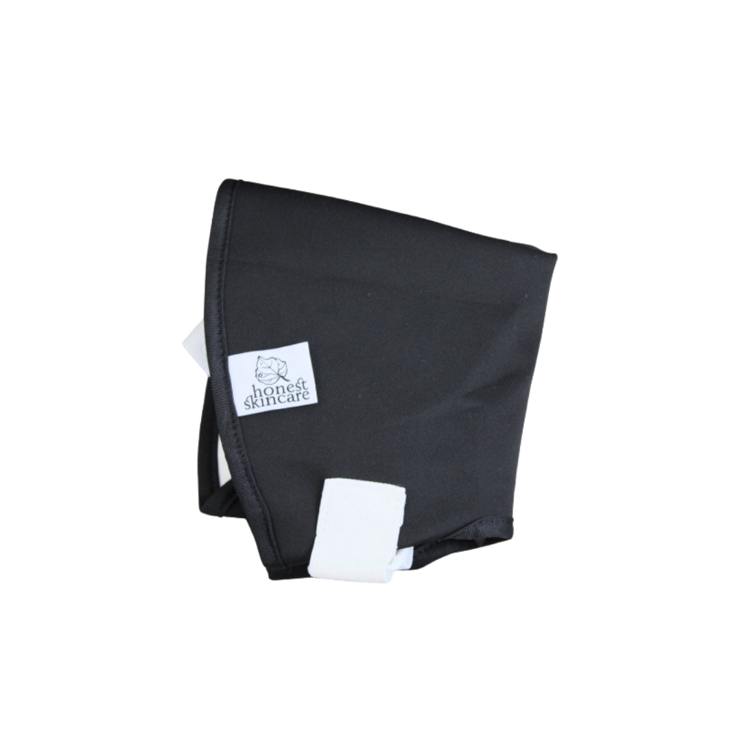 Black castor oil shoulder wrap with a white label on a white background