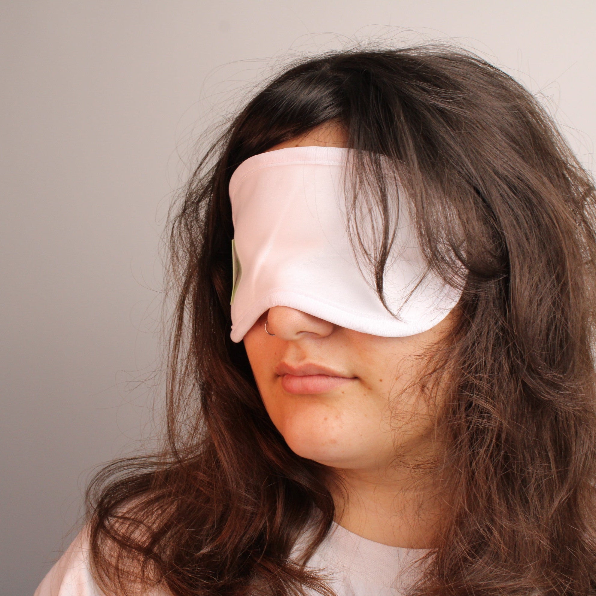 model wearing organic cotton eye mask with plain background
