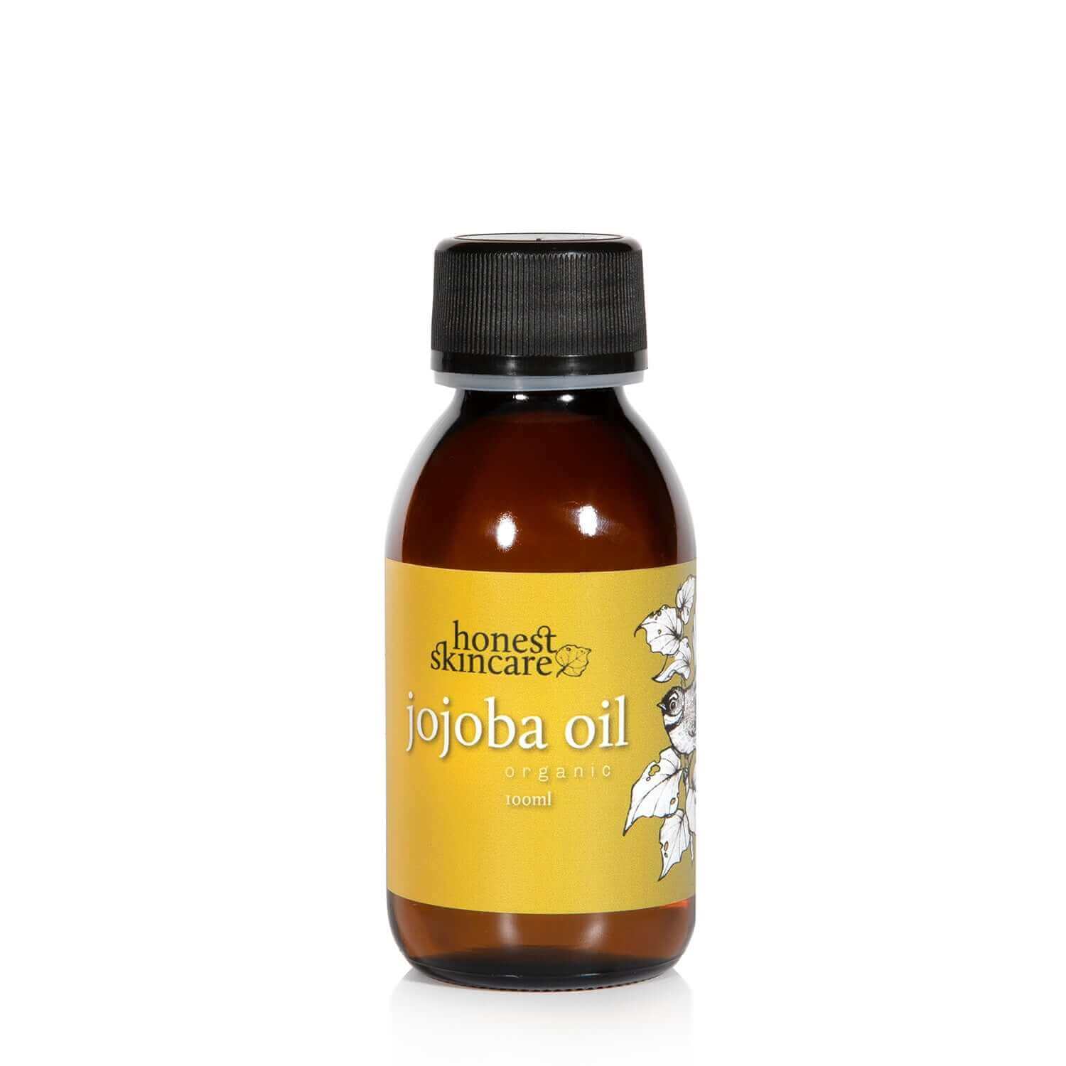 Bottle of honest skincare jojoba oil on a white background