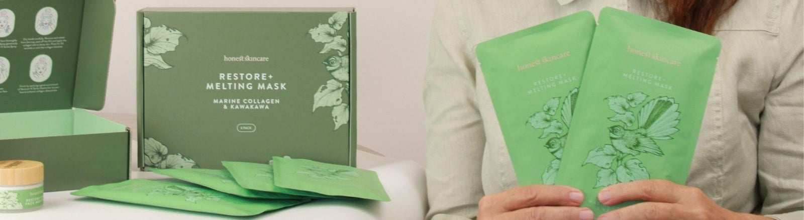 A person holding two green sheet masks next to a green product box labeled 'Restore Melting Mask' on a white table.