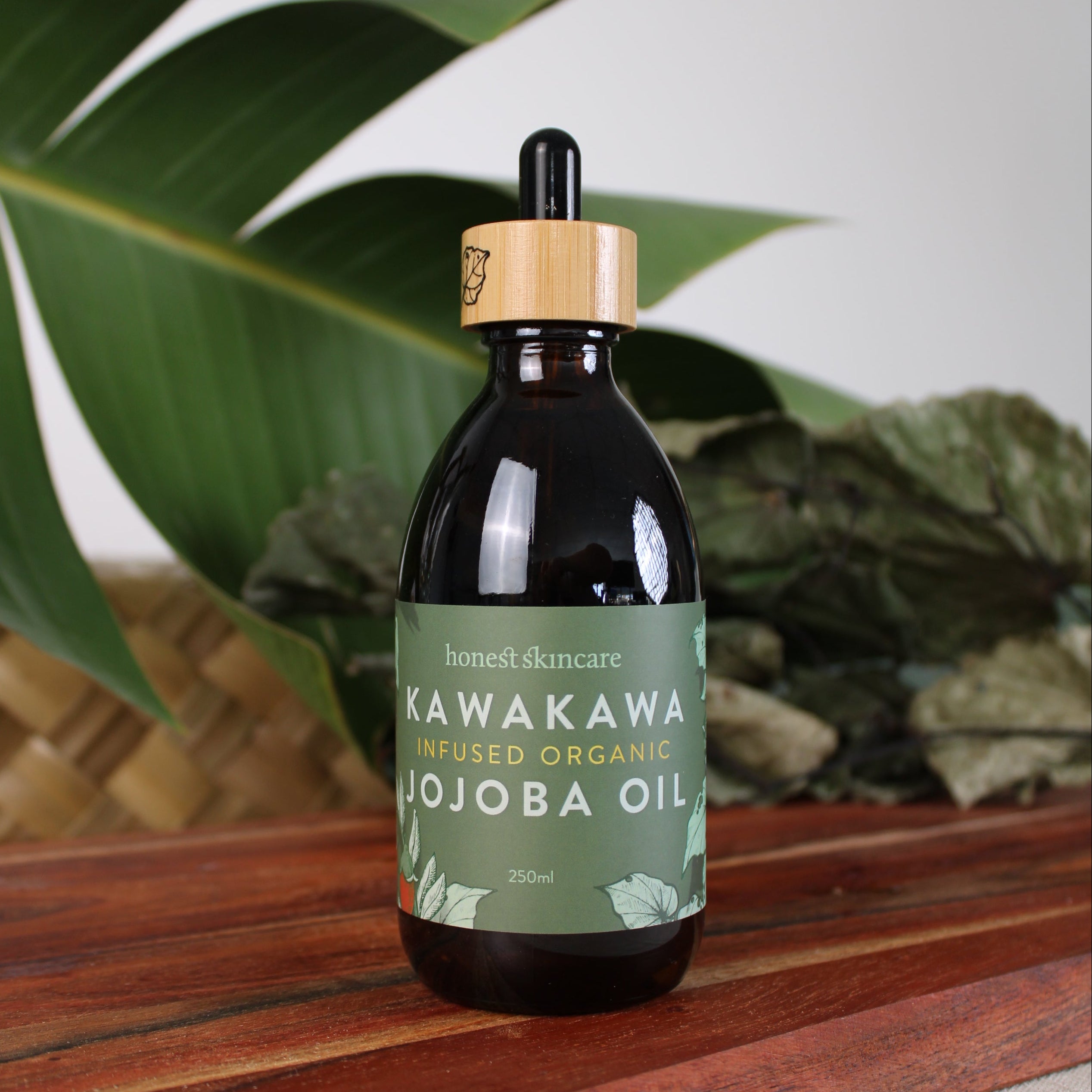 Bottle of Kavakawa Jojoba Oil with dropper against a neutral background