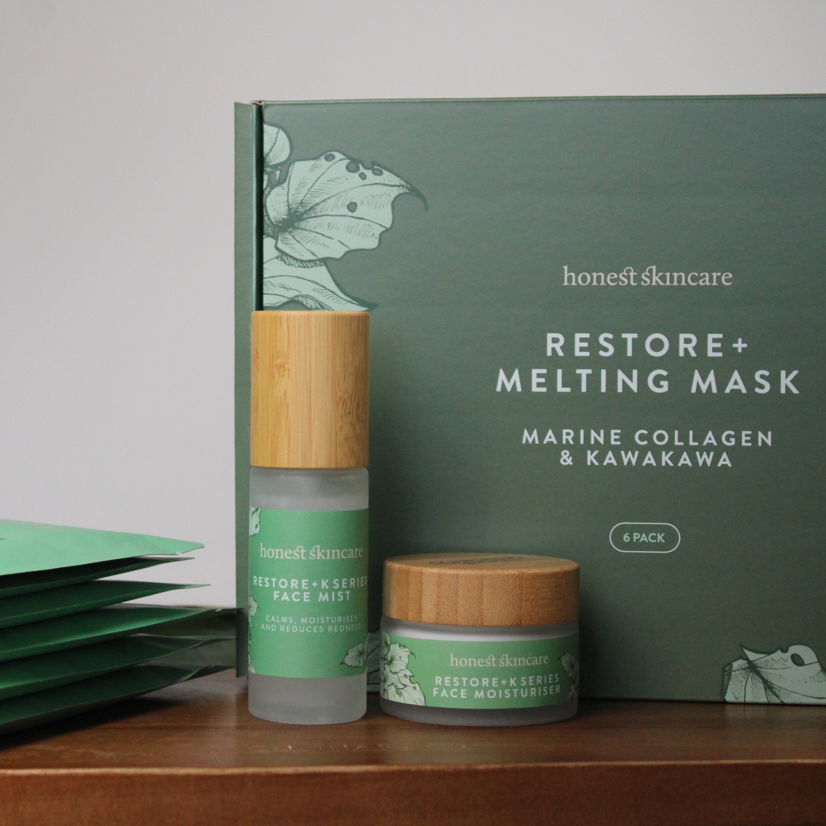 Honest Skincare products including a mask, face mist, and packaging on a wooden surface. Marine collagen melting mask korean skincare