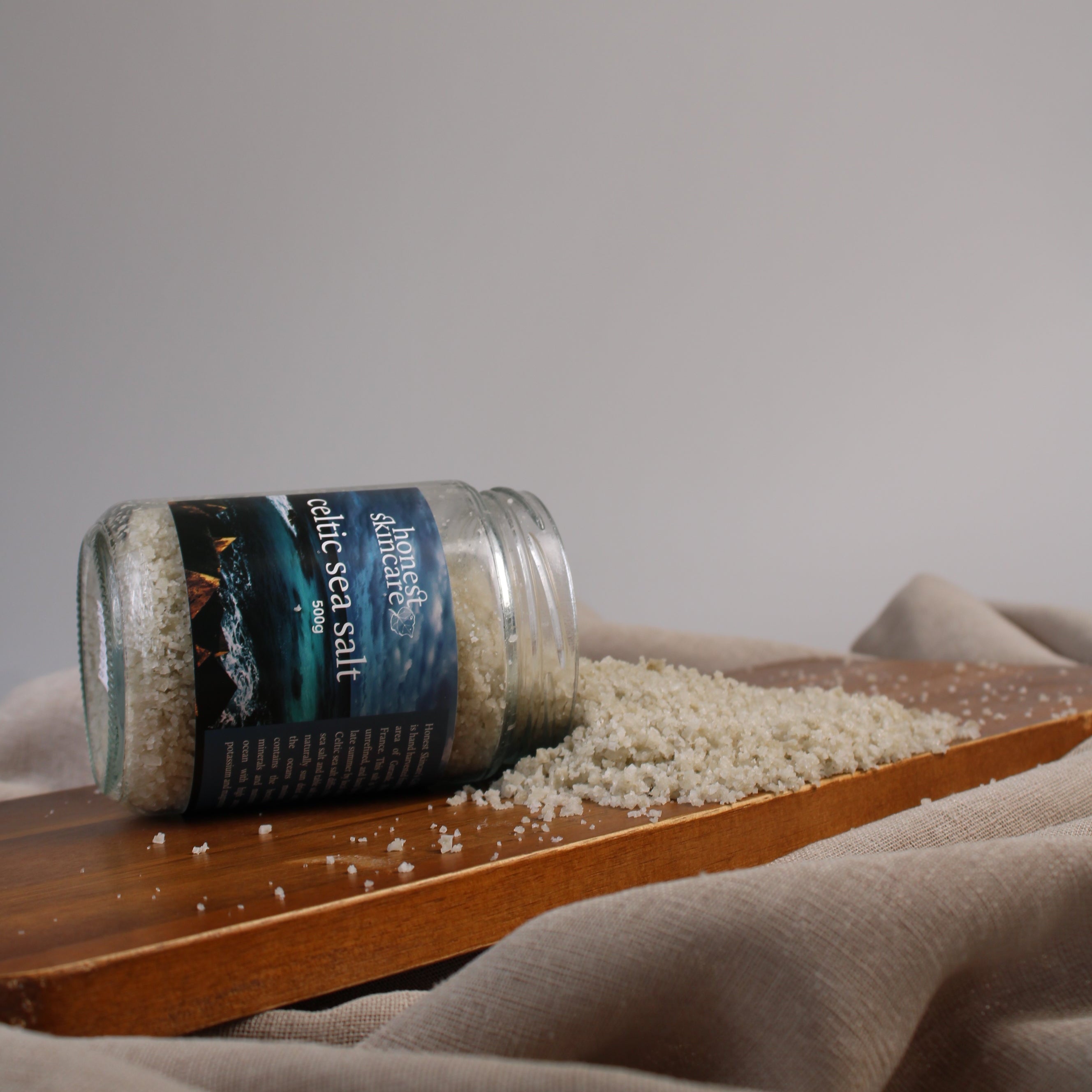 Jar of sea salt with a label on a wooden surface