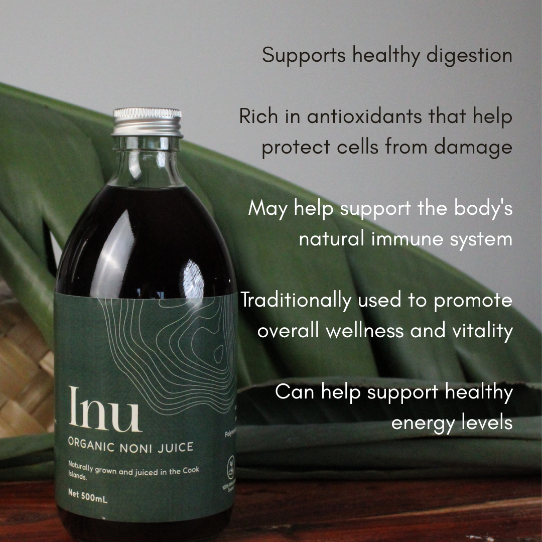 Bottle of Inu Organic Noni Juice with text about its benefits on a wooden surface.